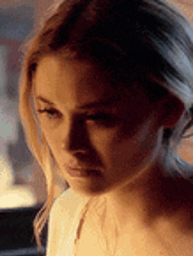 a close up of a woman 's face with a serious look on her face