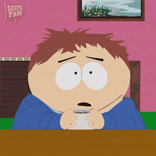 a cartoon character from south park is sitting at a table