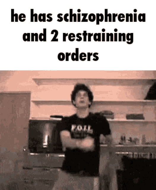 a man in a black shirt is dancing in a kitchen with the words `` he has schizophrenia and 2 restraining orders '' .