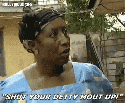 a woman in a blue dress is making a funny face and saying `` shut your deity mout up '' .
