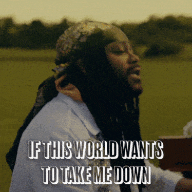a man with dreadlocks and a bandana on his head sings if this world wants to take me down