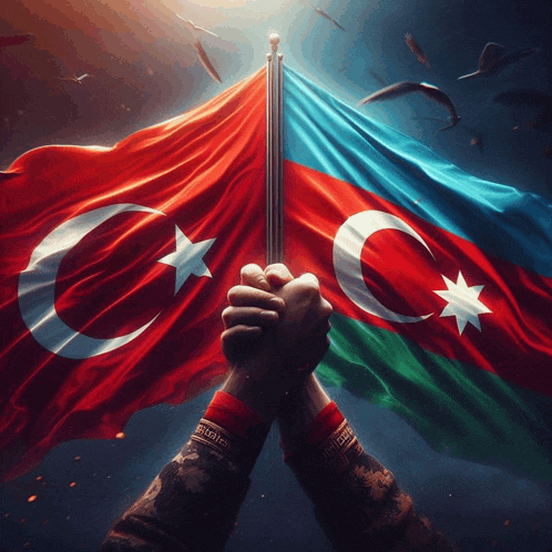 a person holding a turkey and azerbaijan flag together