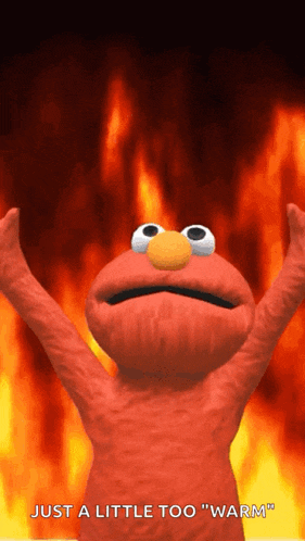 elmo from sesame street is standing in front of a fire and says " just a little too warm "