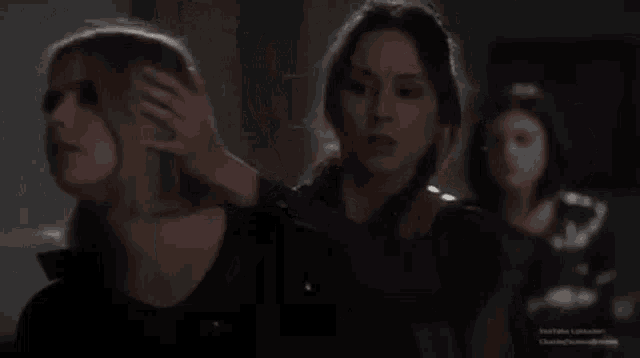 a couple of women are standing next to each other in a room .