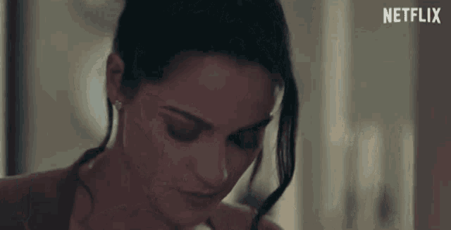a close up of a woman 's face with a netflix logo in the corner .
