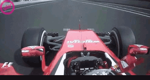 a red ferrari race car is driving down a race track