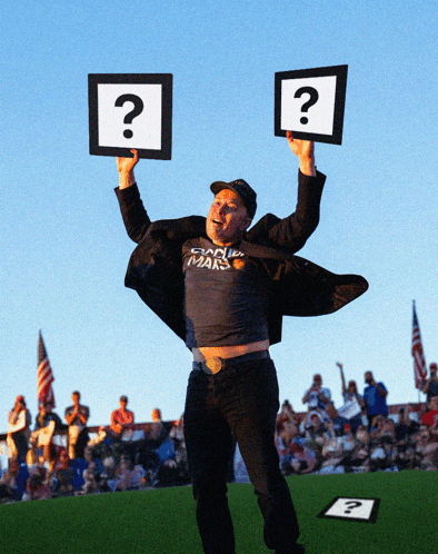 a man in a shirt that says canada mars holds up two signs with question marks on them