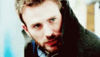 a close up of a man 's face with a beard and blue eyes