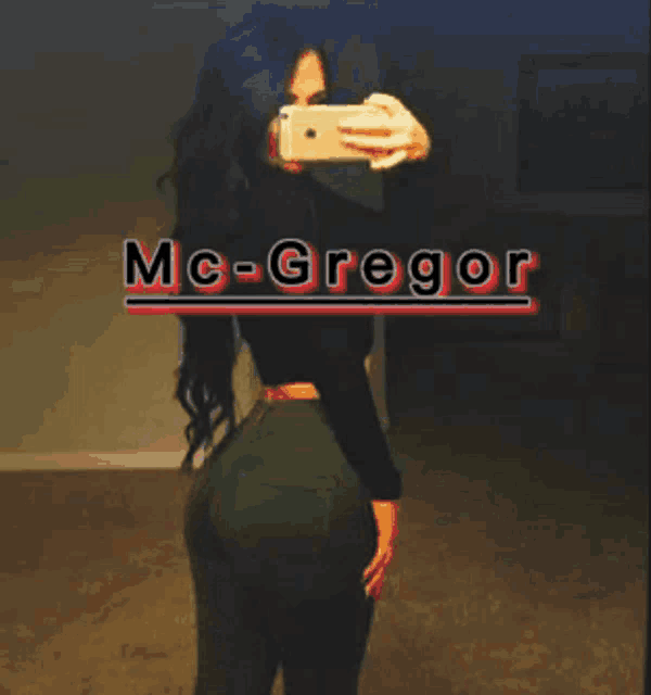 a woman taking a picture of herself with the name mc-gregor