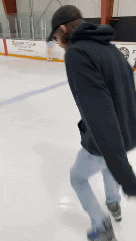 a man ice skating in front of a sign for harris beach