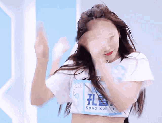 a woman with long hair is wearing a white shirt with the word nike on it .