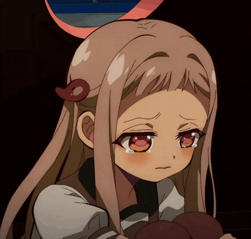 a close up of a girl 's face with tears running down her face