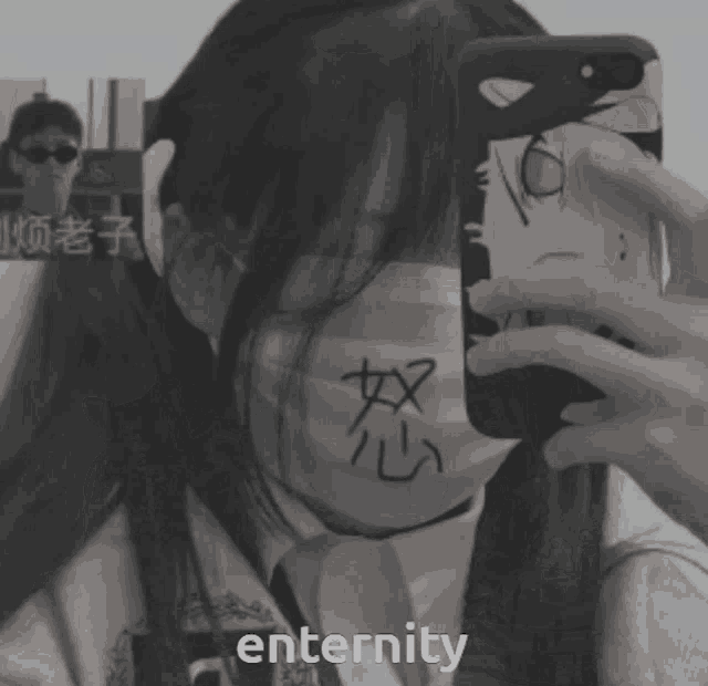 a girl wearing a mask is taking a picture of herself in a mirror with the word eternity in the bottom right corner