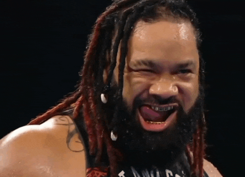 a man with dreadlocks and braces on his teeth