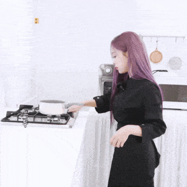 a woman with purple hair is cooking on a stove with the letter t above her head