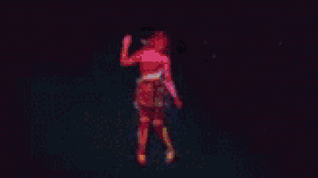 a woman in a red dress is dancing on a stage