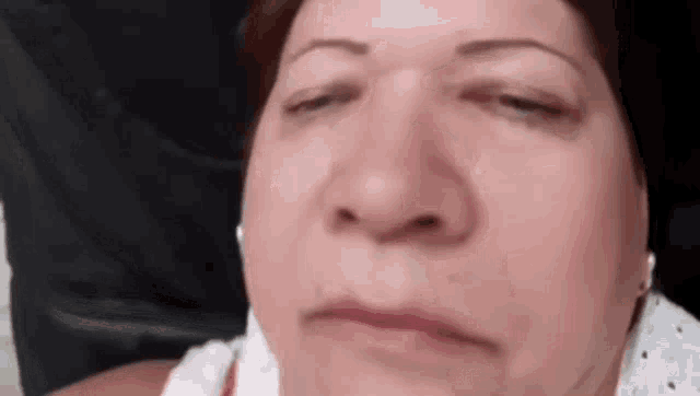 a close up of a woman 's face making a funny face .