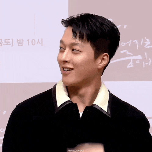 a close up of a man 's face with the words annejangki below it