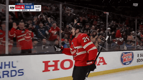a hockey player with the number 29 on his jersey celebrates