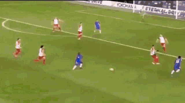 a soccer player with the number 23 on his jersey is kicking the ball .