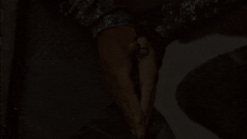 a man and a woman are standing next to each other and the woman 's hand is glowing