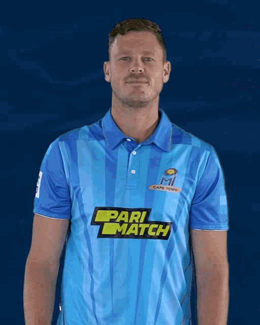 a man wearing a blue shirt with pari match on the front