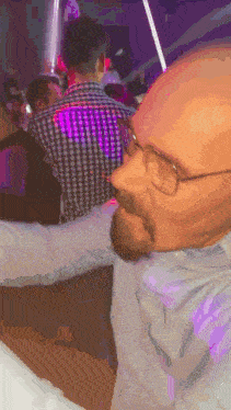 a man with glasses and a beard is dancing