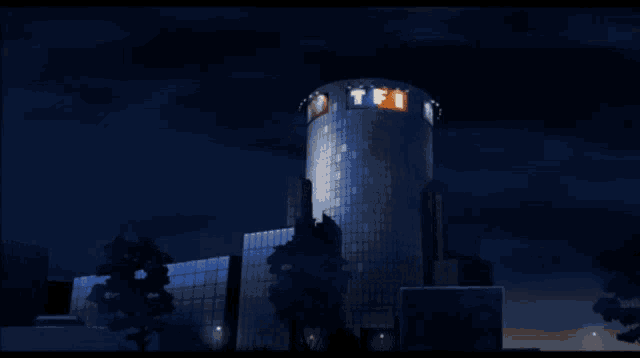 a building with a tfi logo on it at night