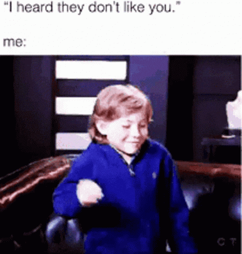 a young boy is sitting on a couch and dancing .
