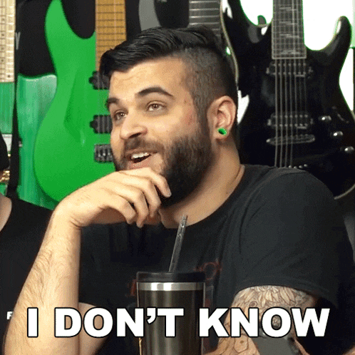 a man with a beard and green ear plugs says i don t know