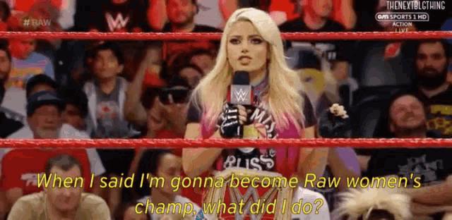 a woman stands in a wrestling ring holding a microphone and says when i said i 'm gonna