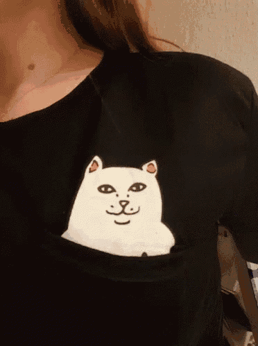 a woman is wearing a black shirt with a white cat in a pocket