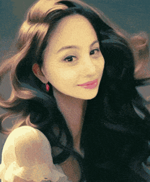 a woman with long black hair is wearing a white top