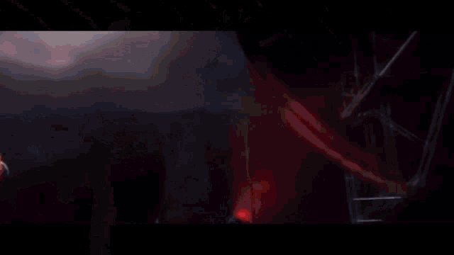 a spider man is flying through the air in front of a castle .