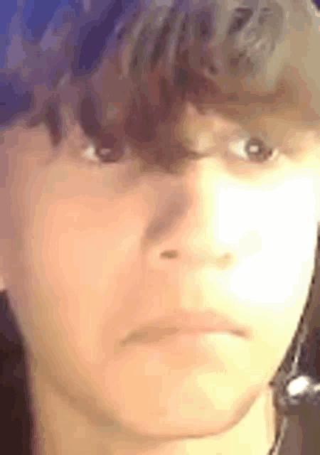 a close up of a person 's face with a serious look on his face .