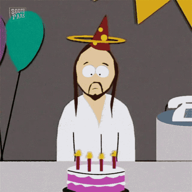 jesus from south park is wearing a party hat and sitting in front of a birthday cake .