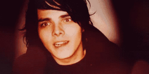 a close up of a man 's face with a black shirt on .