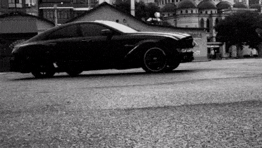 a black car is parked in front of a building that has the number 22 on it