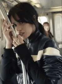 a woman is talking on a cell phone on a train