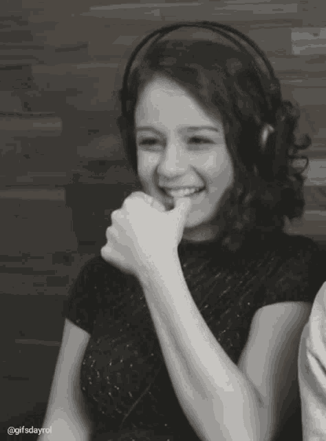 a black and white photo of a woman wearing headphones with the hashtag gifsdayrol at the bottom