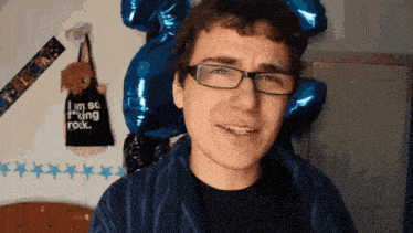 a man wearing glasses and a black shirt that says i 'm so f * cking rock
