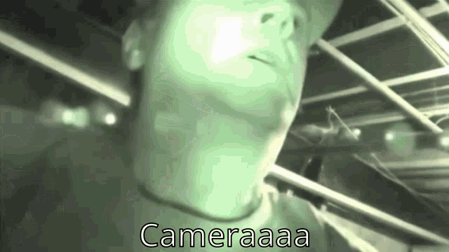 a black and white photo of a man with the words cameraaaa on the bottom right