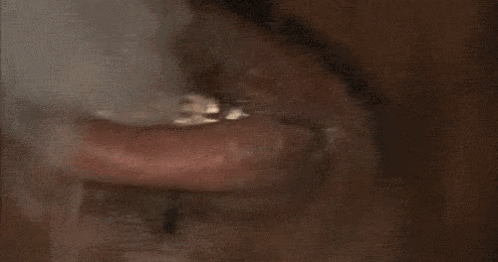 a close up of a man 's mouth with a ring on his teeth that says i need money