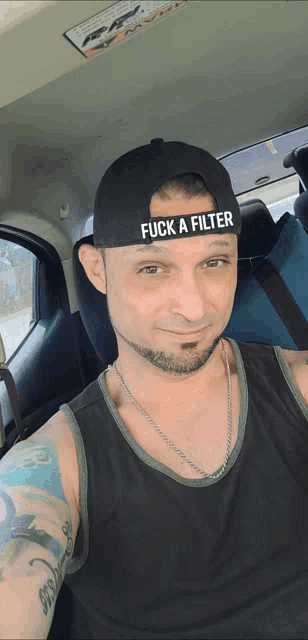 a man is wearing a hat that says fuck a filter