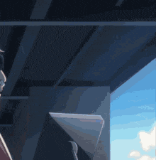 a man in a suit is standing under a bridge looking out the window .