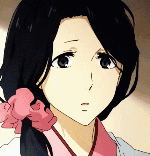 a close up of a girl 's face with a pink bow in her hair