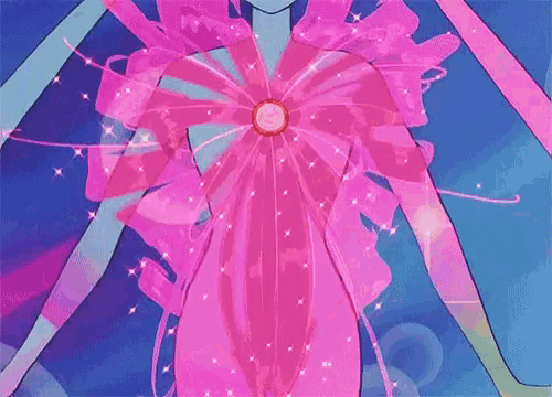 a woman is wearing a pink bow on her chest .