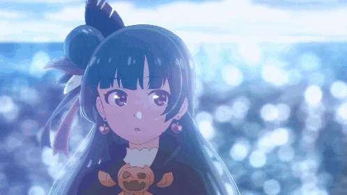 a girl with a pumpkin on her chest is standing in front of a body of water