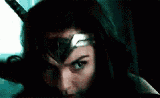 a close up of a woman wearing a wonder woman costume and a helmet .