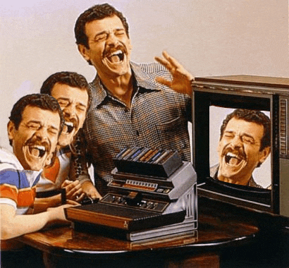 a group of men are laughing in front of an atari video game console
